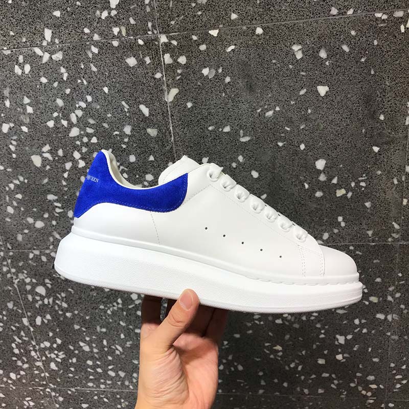 Top-down look at white leather and laces on Alexander McQueen oversized sneakers
