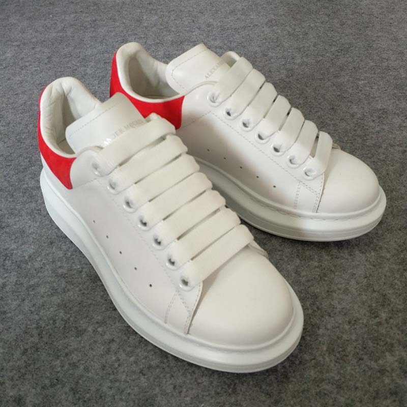 Close-up of Alexander McQueen Women Oversized Sneaker Shoes-Red signature heel tab