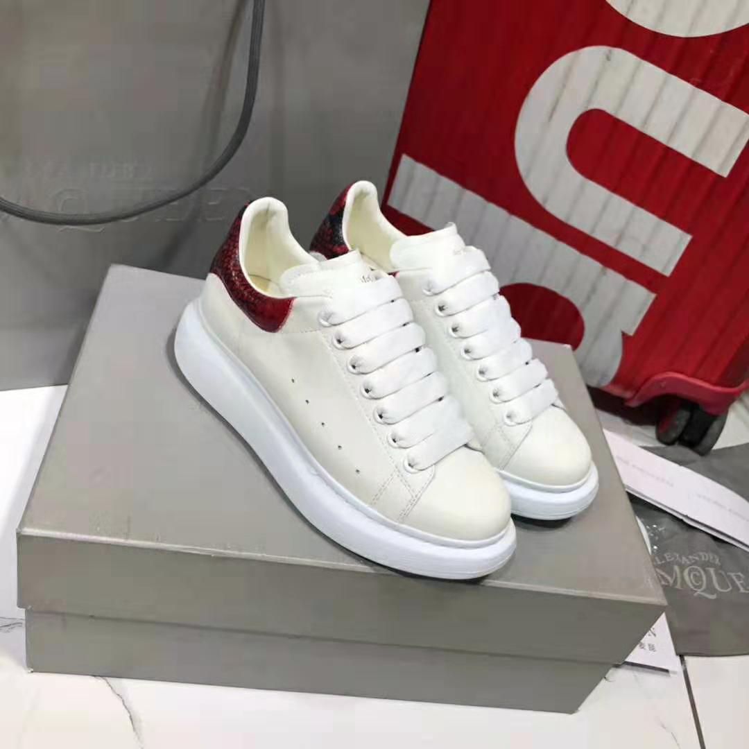 Side profile highlighting oversized silhouette of Alexander Mcqueen Men White Leather Sneaker