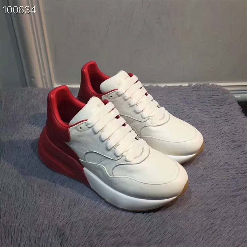 Close-up of red accent and thick sole on Alexander Mcqueen Unisex Oversized Runner