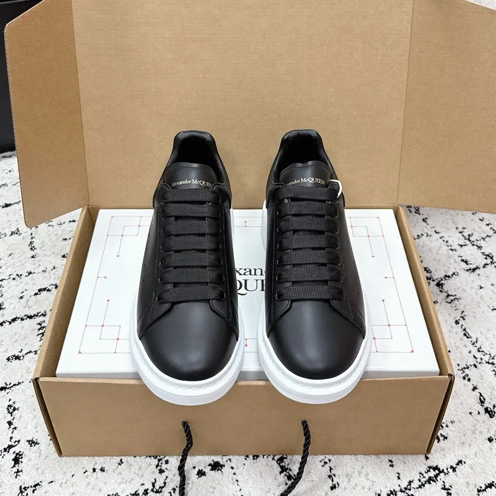 Close-up of lace-up detail on Alexander Mcqueen Unisex Oversized Sneaker Black leather