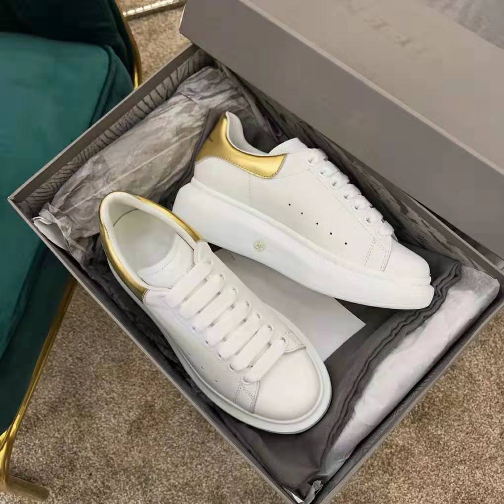 Close-up of smooth white calf leather and branded heel on Alexander Mcqueen oversized sneaker