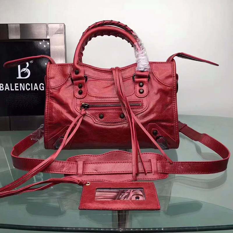 Close-up of silver hardware and red leather texture on Balenciaga bag