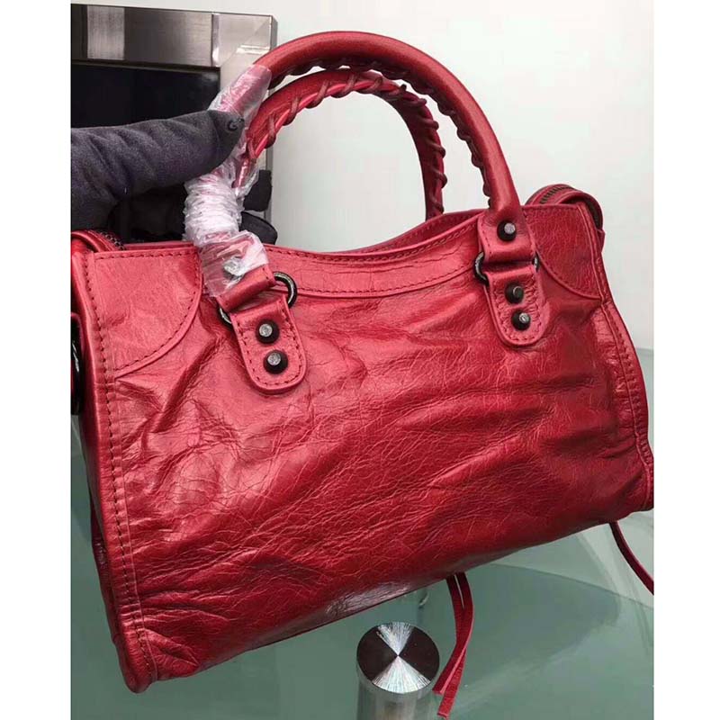 Side angle showcasing the top handle and shoulder strap on Balenciaga bag