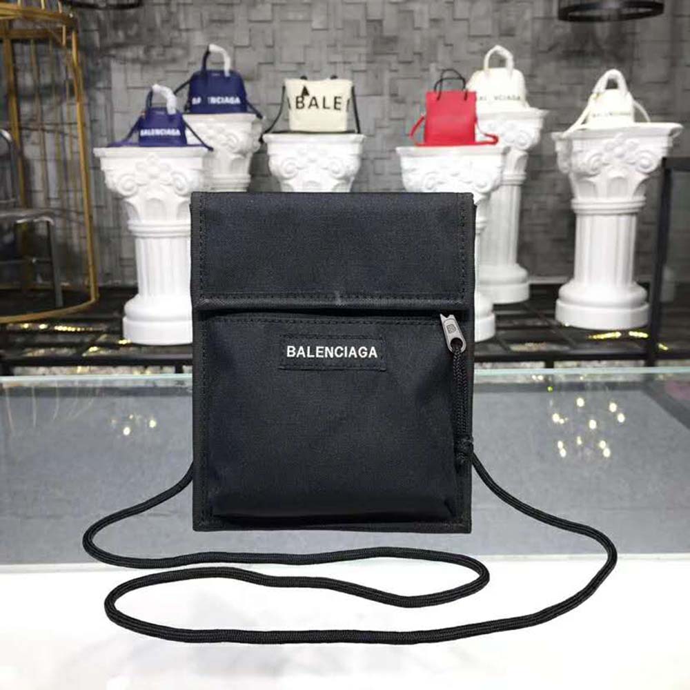 Close-up of embossed Balenciaga logo on black leather pouch strap