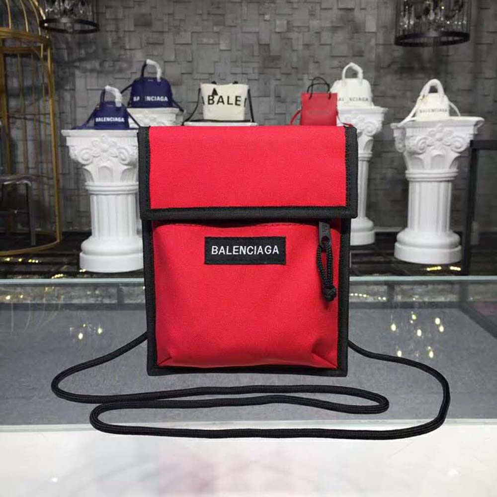 Close-up of red leather texture and silver hardware on Balenciaga pouch