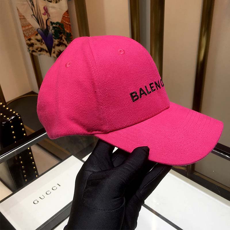 Side view showing adjustable strap and metal buckle on pink cap