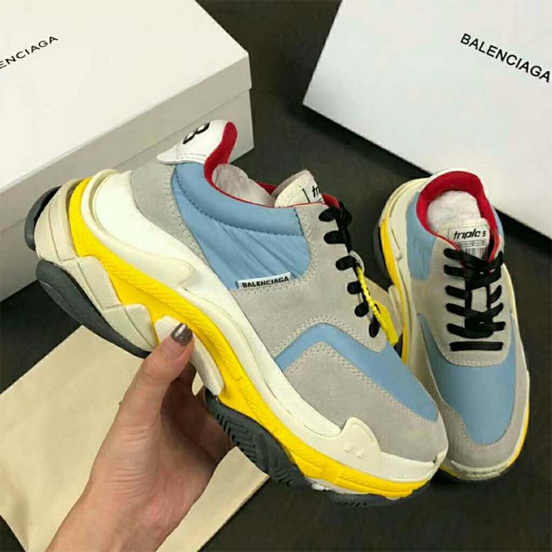 Top-down image showing laces and mesh-leather texture on Balenciaga Triple S sneakers