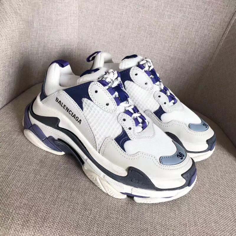 Close-up on quilted textile and leather mix of Balenciaga Triple S Trainers white sneakers