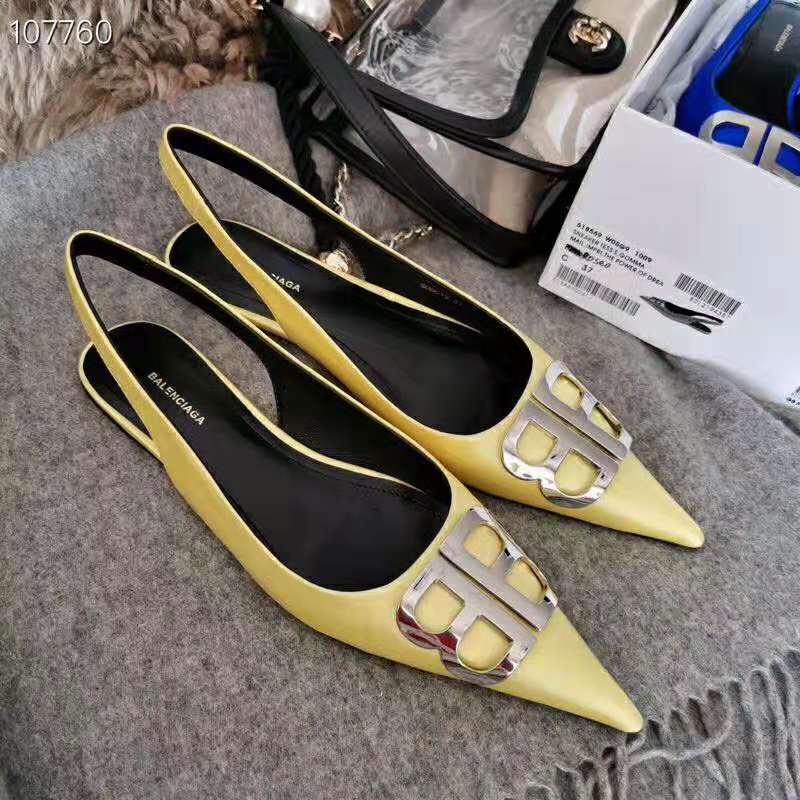 Close-up detail of yellow satin and BB hardware on slingback ballerina