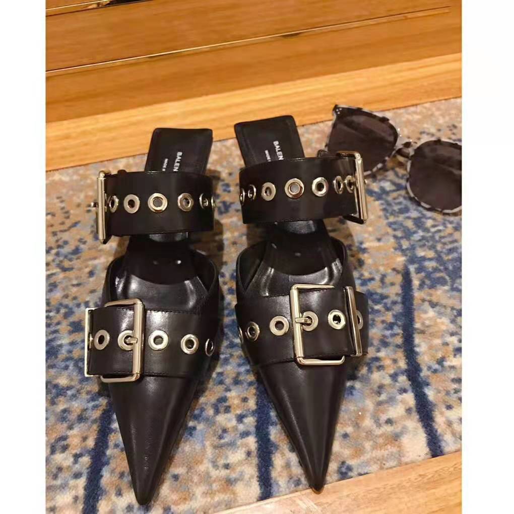 Close-up detail of glossy patent leather and BB hardware on Balenciaga slingback