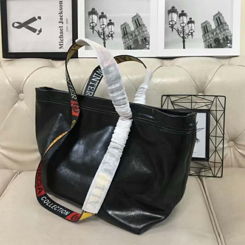 Side view showing silhouette of Balenciaga Women Carry Logo Handles Shopper M bag