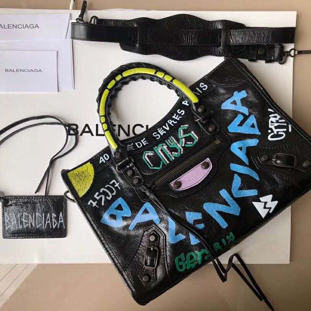 Close-up of graffiti logo and silver hardware on blue Balenciaga bag