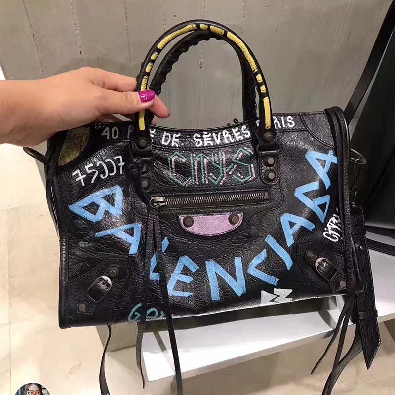 Side angle showing silhouette and adjustable strap of Balenciaga Women Classic City S Graffiti Small Shoulder Bag