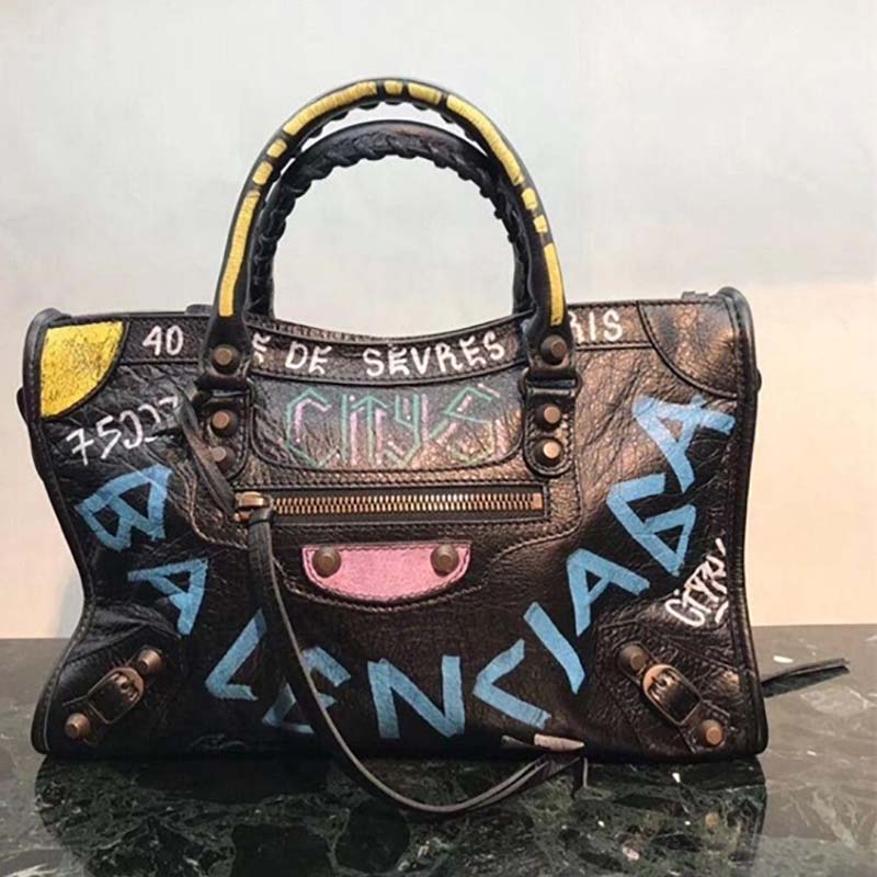 Close-up on silver-tone hardware and graffiti print detail on Balenciaga shoulder bag