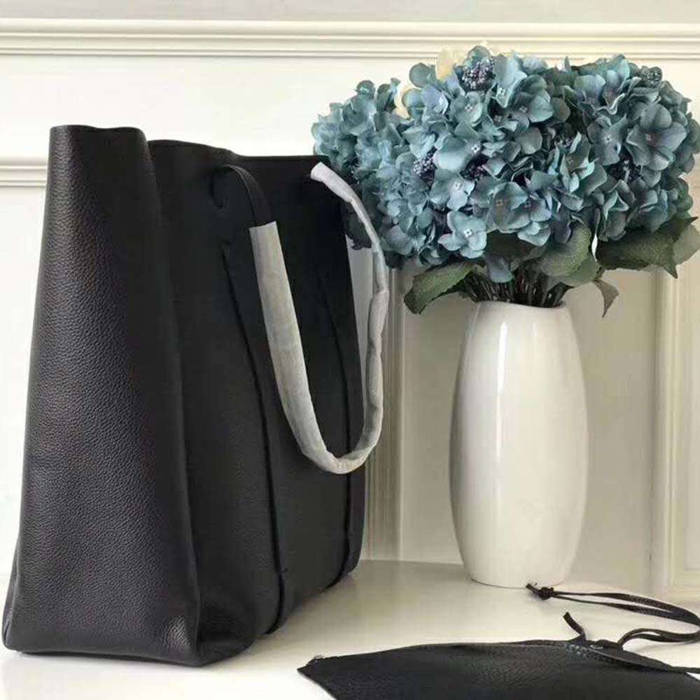 Side profile showing thin handles and compact silhouette of Balenciaga tote