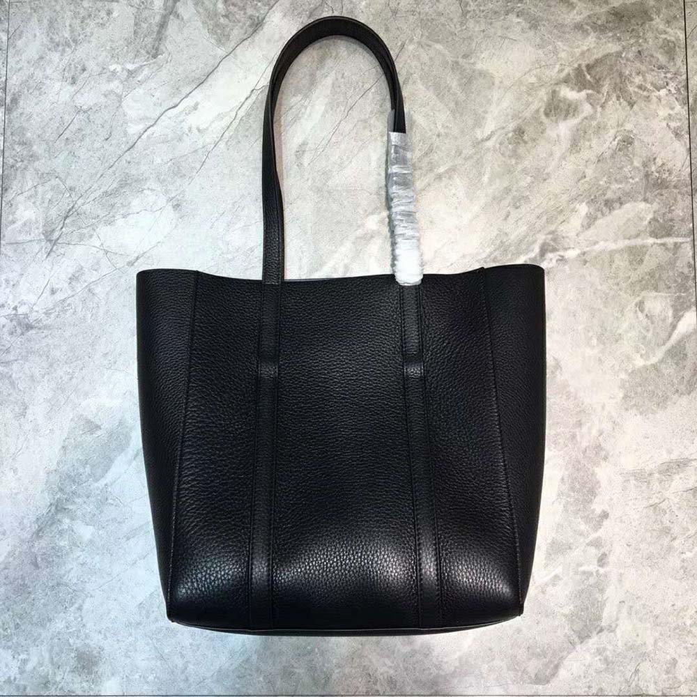 Side angle showing slim profile and thin handles of Balenciaga Everyday Tote XXS