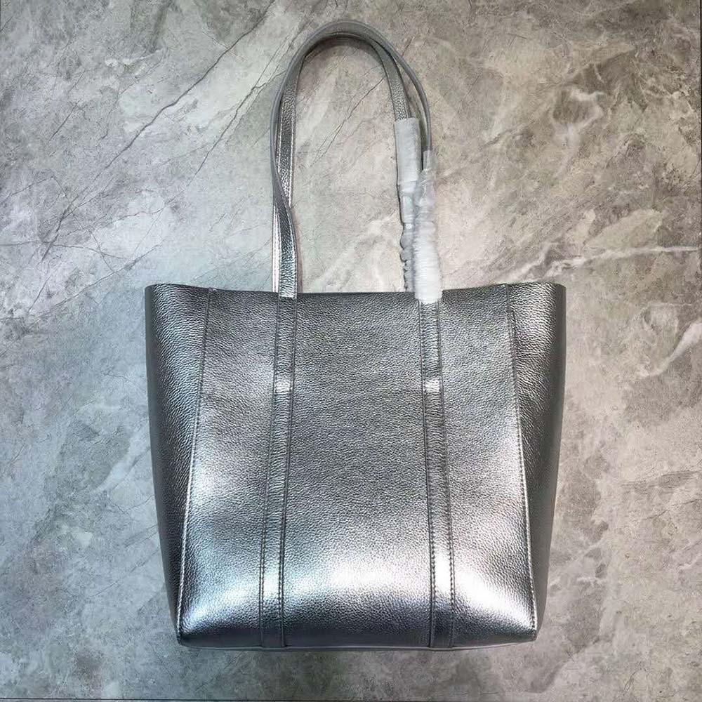 Side profile showing compact silhouette of Balenciaga Women Everyday Tote XXS