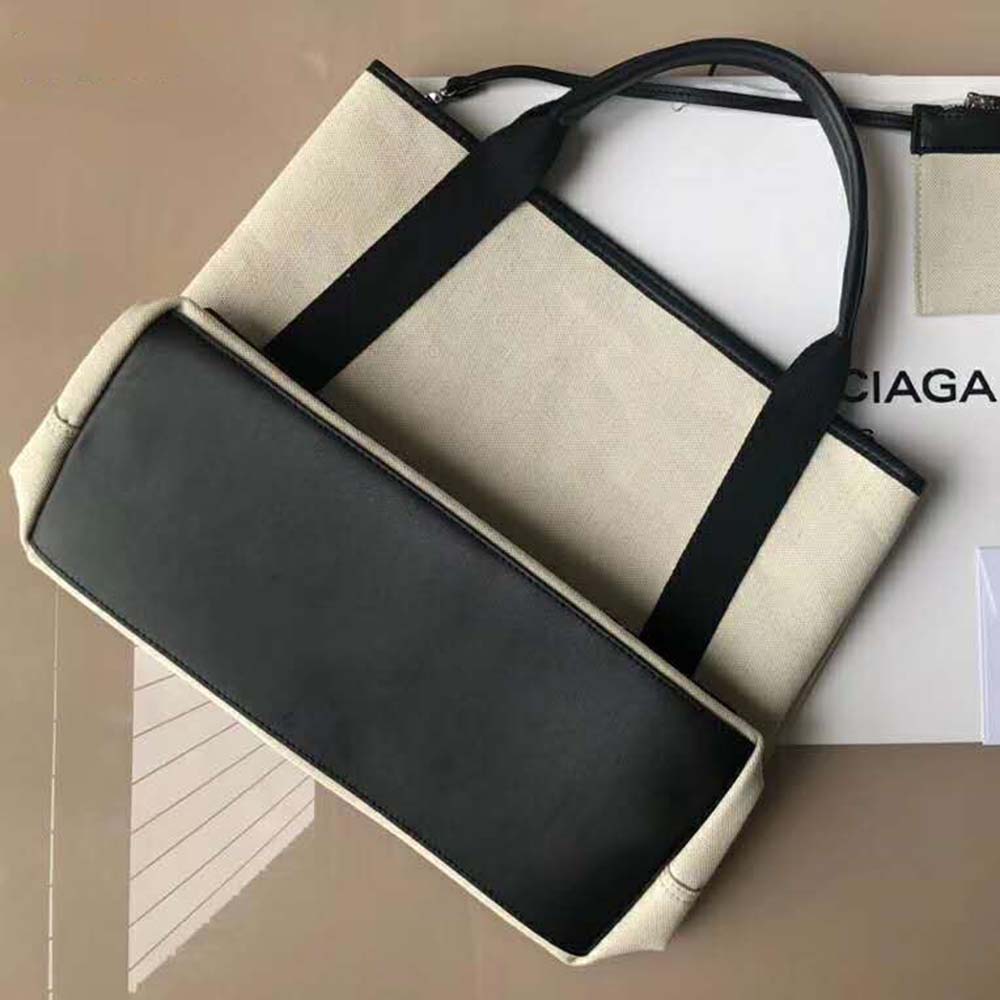 Side angle showing spacious interior of Balenciaga Women Navy Cabas M bag