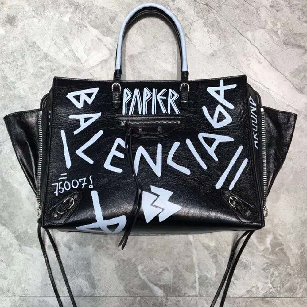 Close-up of graffiti print and silver zip on Balenciaga crossbody bag