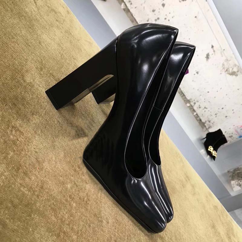 View of the 110mm heel and rounded toe on Balenciaga black pumps