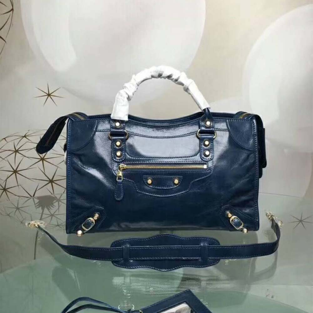 Close-up detail of navy lambskin leather texture and silver hardware on Balenciaga bag