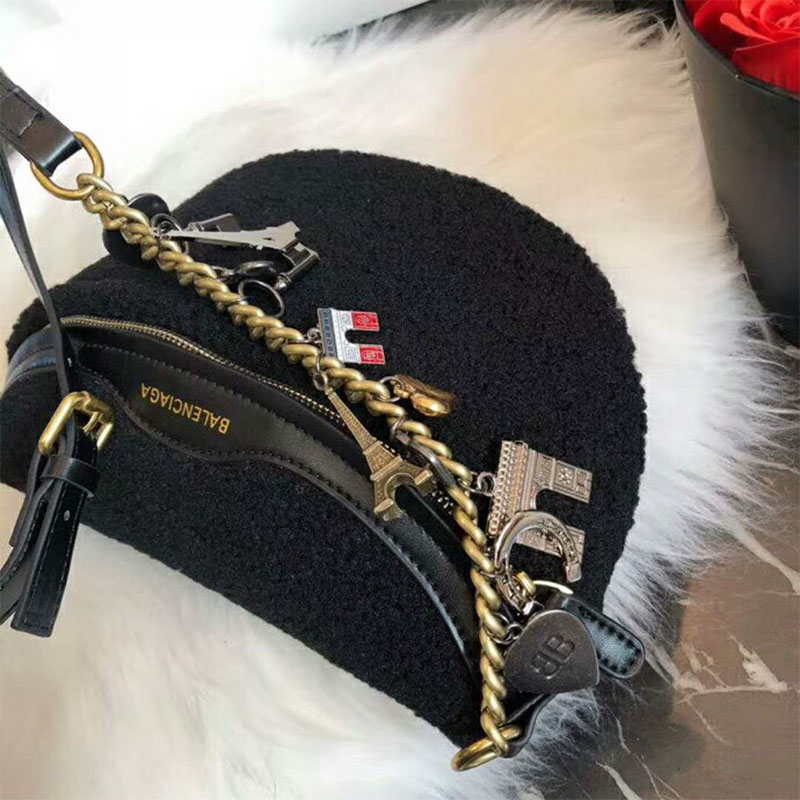 Side profile showing compact silhouette and adjustable strap on Balenciaga bag