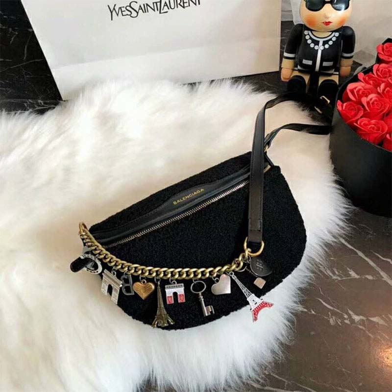 Close-up of gold belt buckle and velvet jacquard texture on Balenciaga bag
