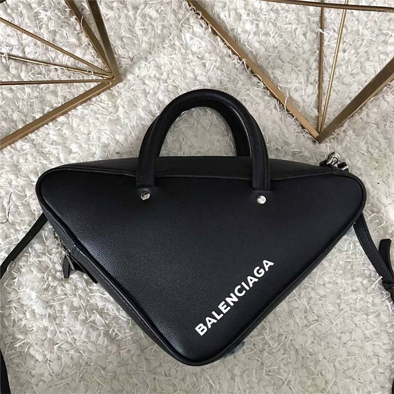 Close-up of silver Balenciaga hardware on black calfskin duffle bag