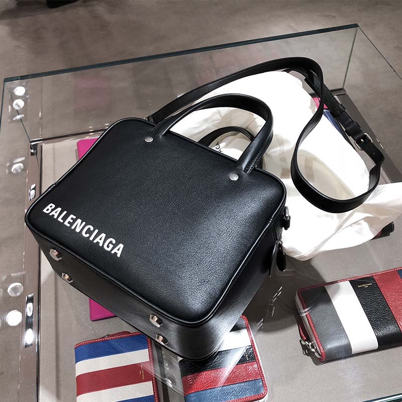 Side angle showing triangular silhouette of Balenciaga Women Triangle Square XS Bag