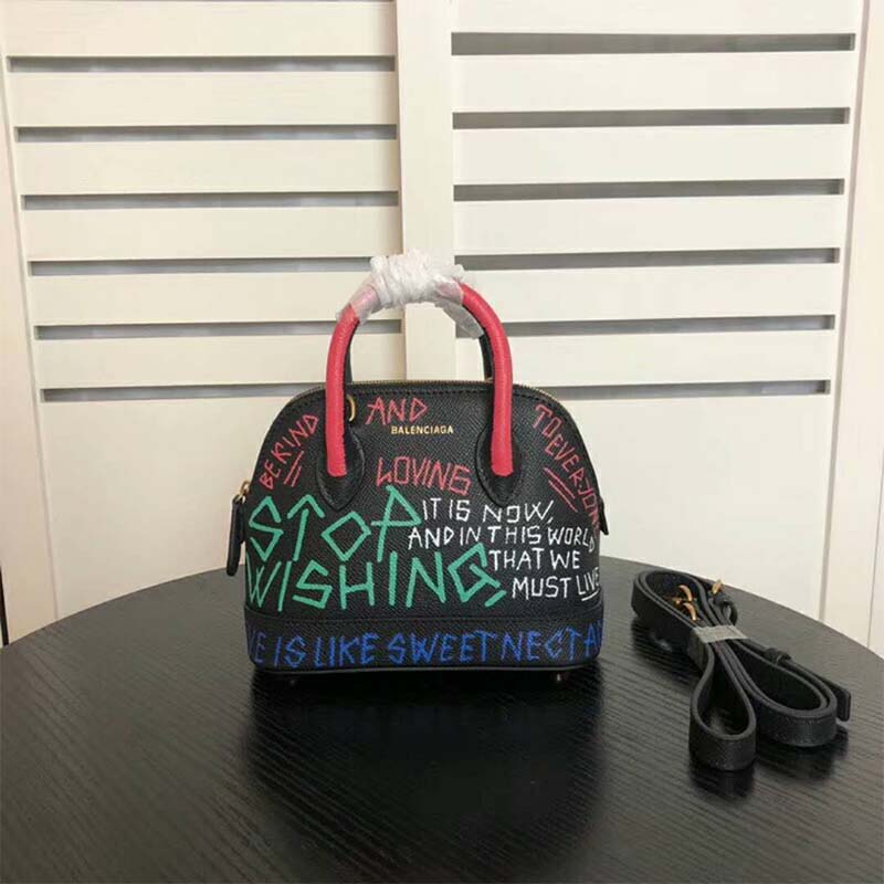Close-up of graffiti detail and silver hardware on Balenciaga Ville handbag