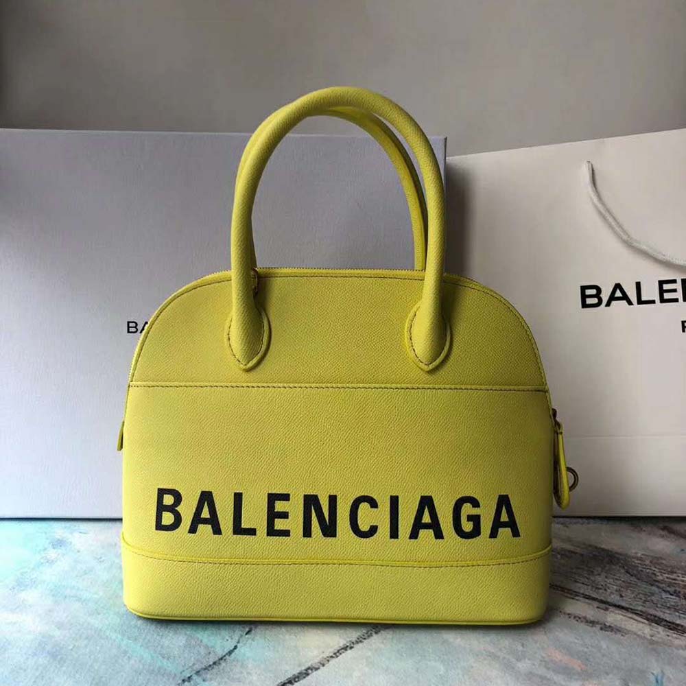 Side angle showing silver hardware and top handle of Balenciaga Ville XXS bag