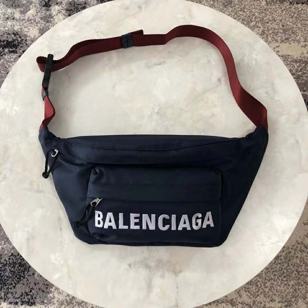 Close-up of embroidered Balenciaga logo on navy nylon beltpack