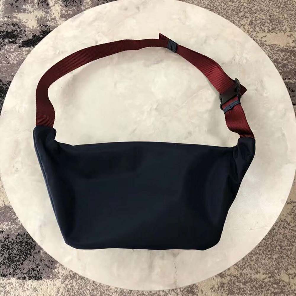 Side angle showing adjustable strap and silver hardware on beltpack
