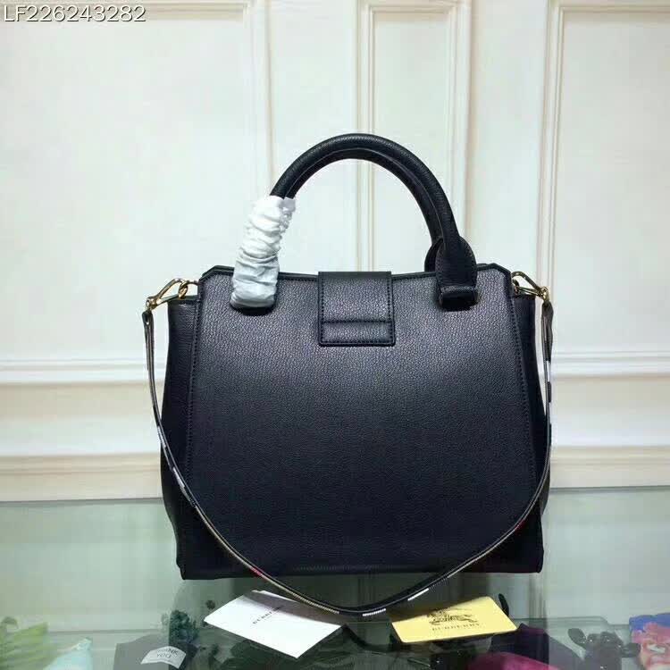 Side profile showing structured silhouette of Burberry Medium Buckle Tote in Grainy Leather-Black