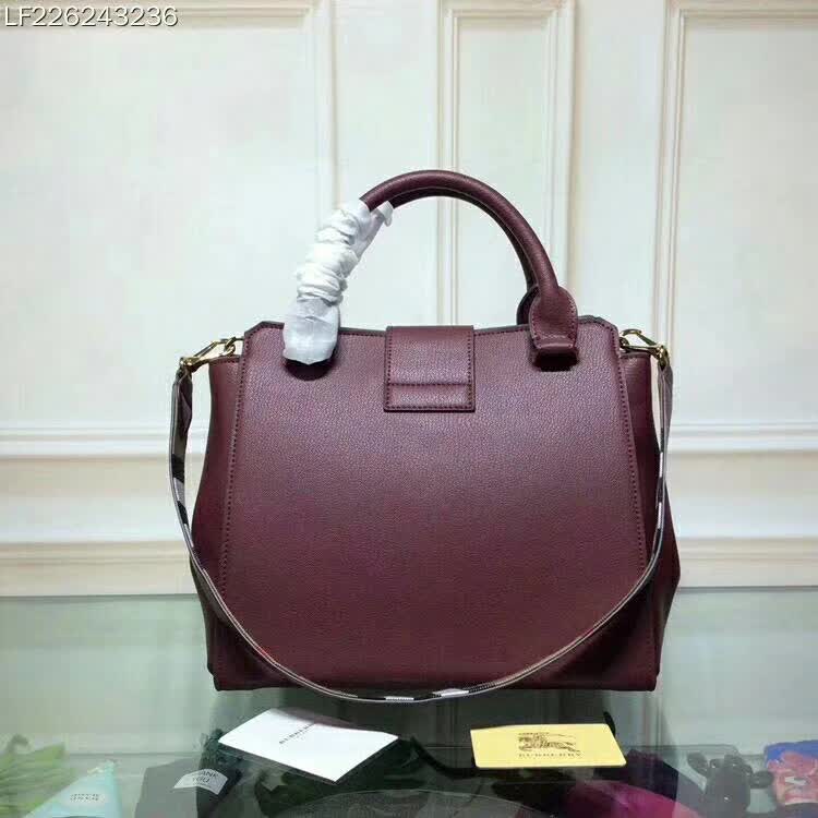 Side angle showing grainy leather texture on Burberry Medium Buckle Tote