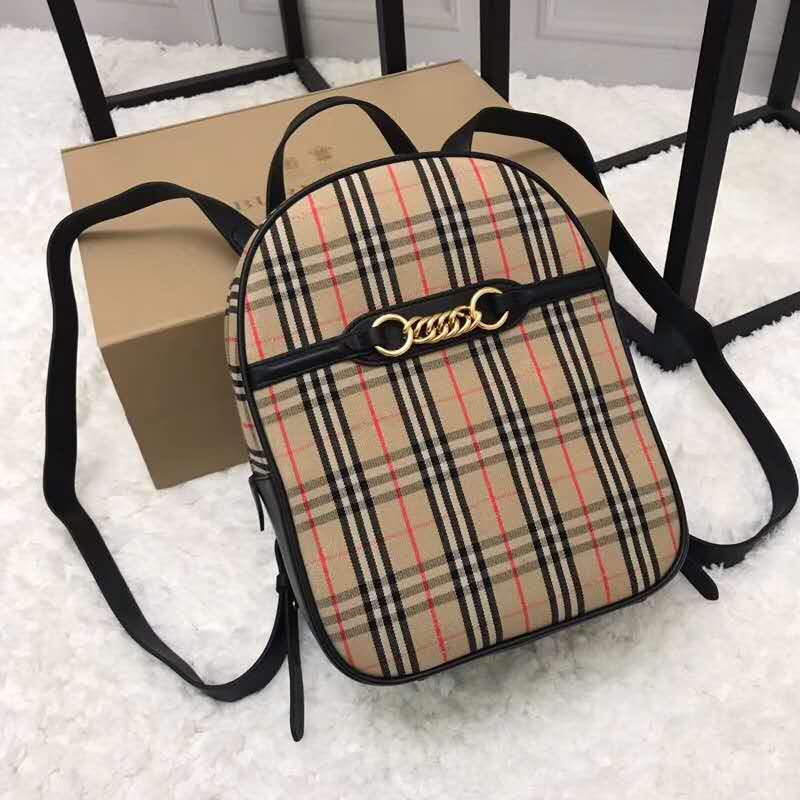 Side angle showing coated canvas and leather trim on Burberry backpack