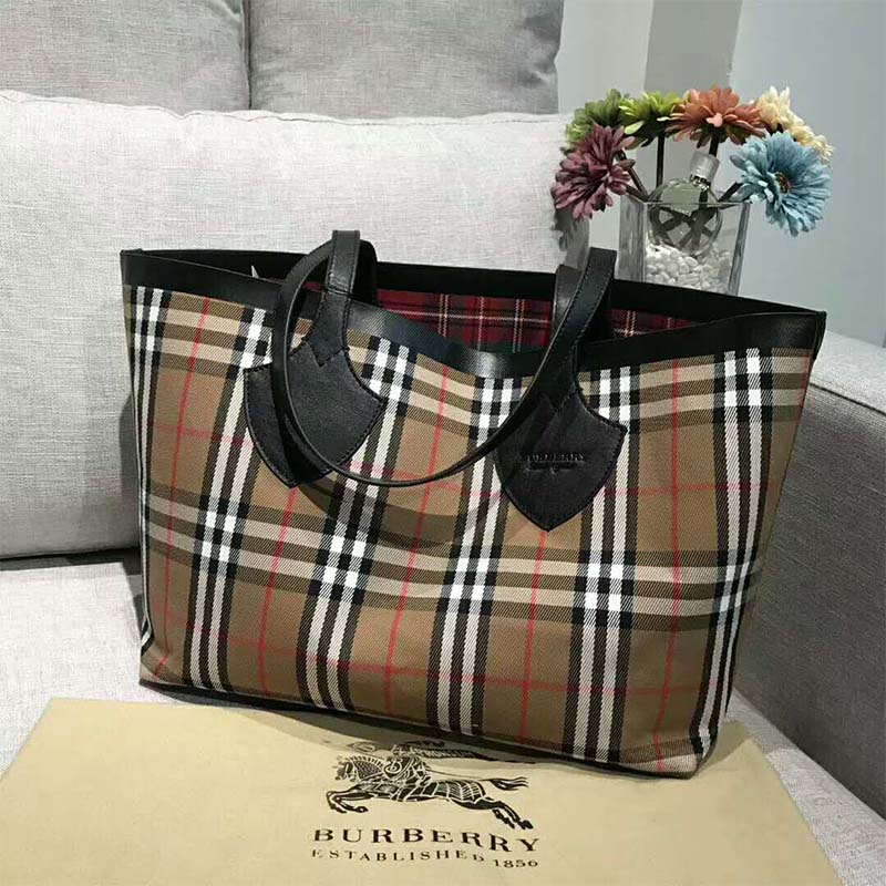 Close-up of vintage check pattern and leather trim on Burberry reversible tote
