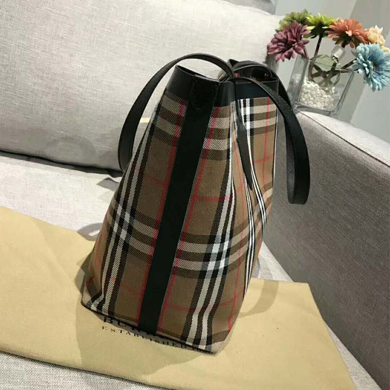 Side angle showing brushed gold-tone hardware on Burberry medium tote