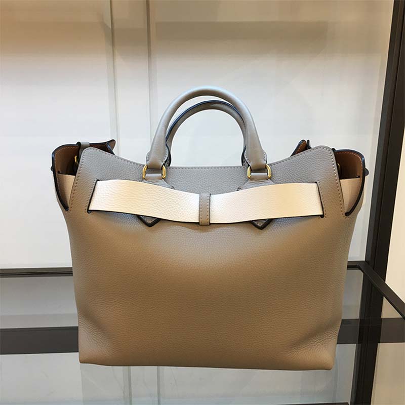 Side angle showing adjustable strap and sleek silhouette of Burberry silver belt bag