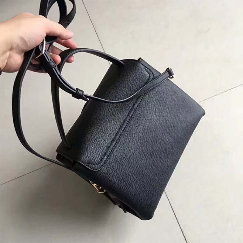 Side angle showing grainy black leather texture on Burberry tote
