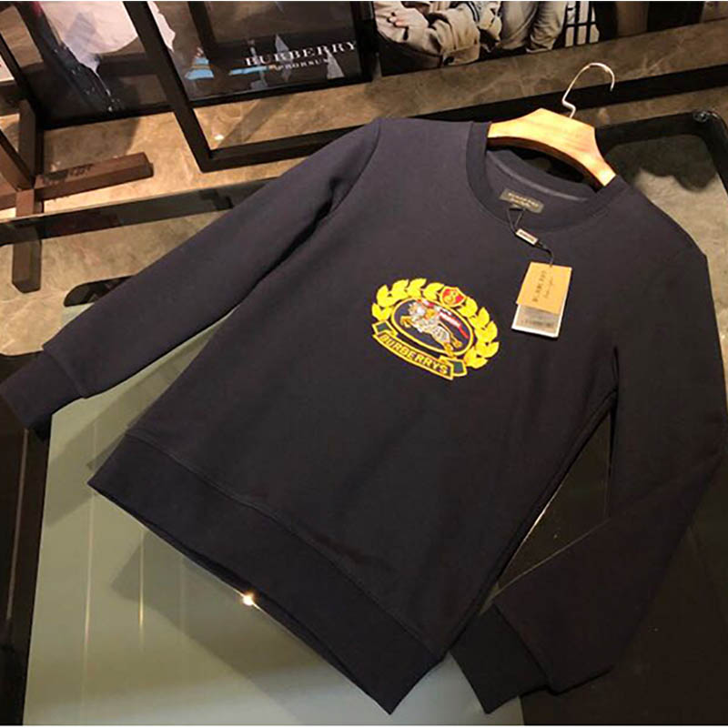 Model wearing Burberry Men Reissued Jersey Sweatshirt-Navy styled with jeans