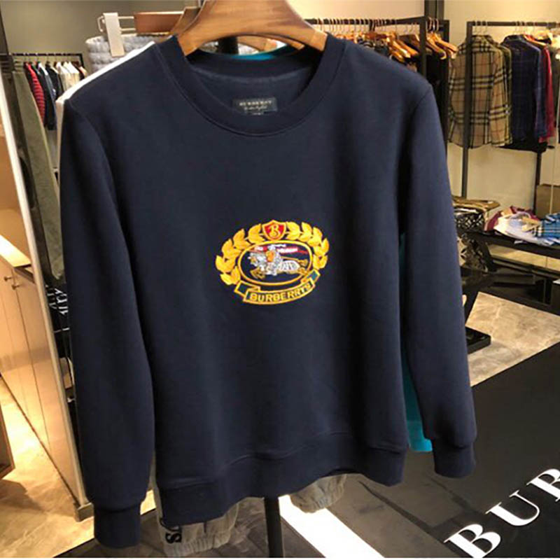 Close-up detail of navy cotton jersey fabric and ribbed cuff on sweatshirt