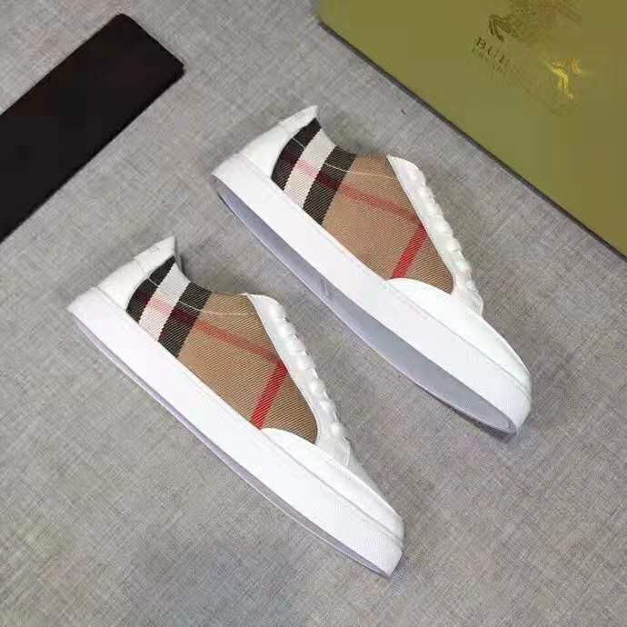 Top-down angle highlighting white leather and lace-up design of Burberry sneakers