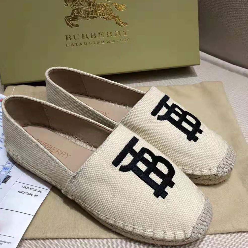Close-up of Burberry monogram detail on white leather espadrille