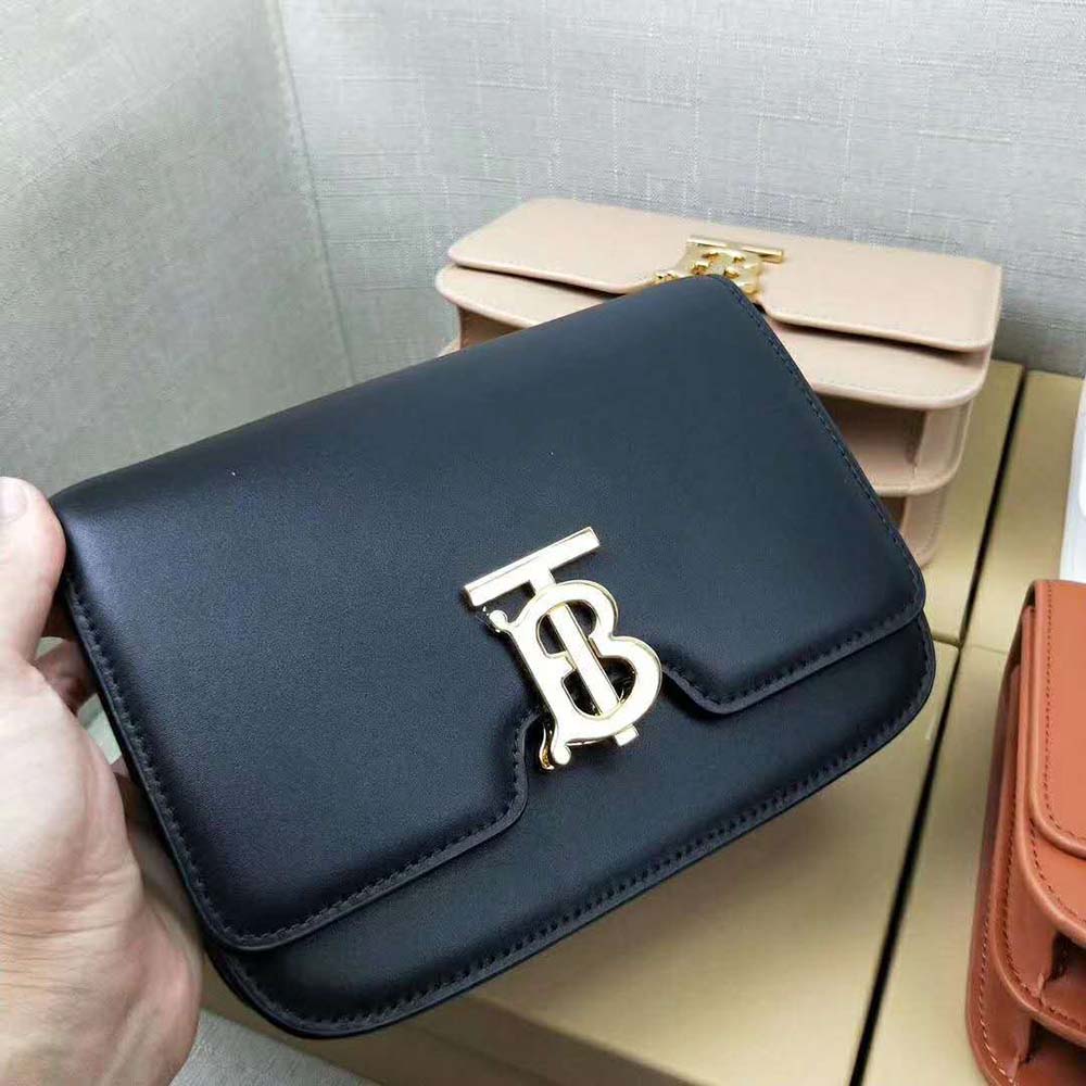 Close-up of adjustable strap and signature TB logo clasp on bag