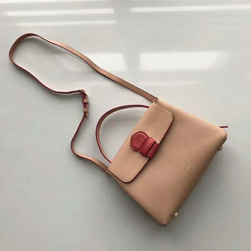 Close-up detail of pink leather and House Check canvas on tote