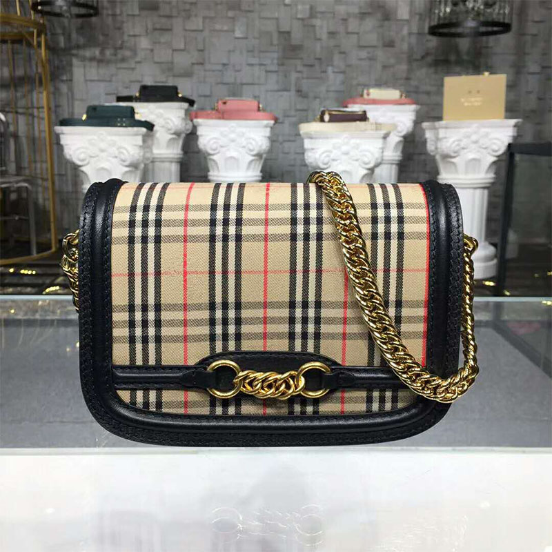 Close-up of silver chain strap and leather trim on Burberry bag