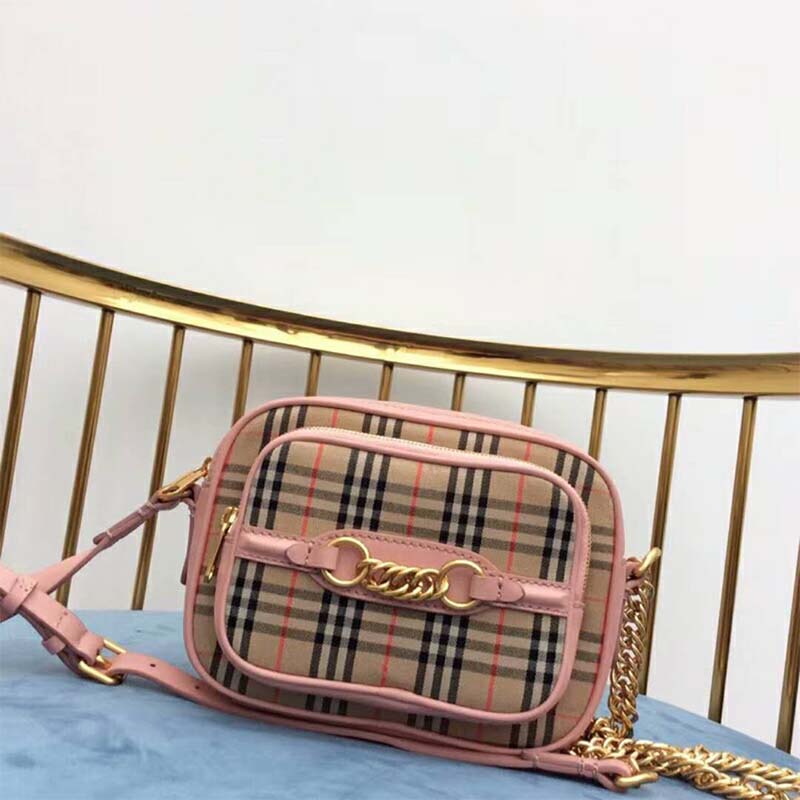Close-up of gold-tone check link hardware on Burberry Women The 1983 Check Link Camera Bag-Pink