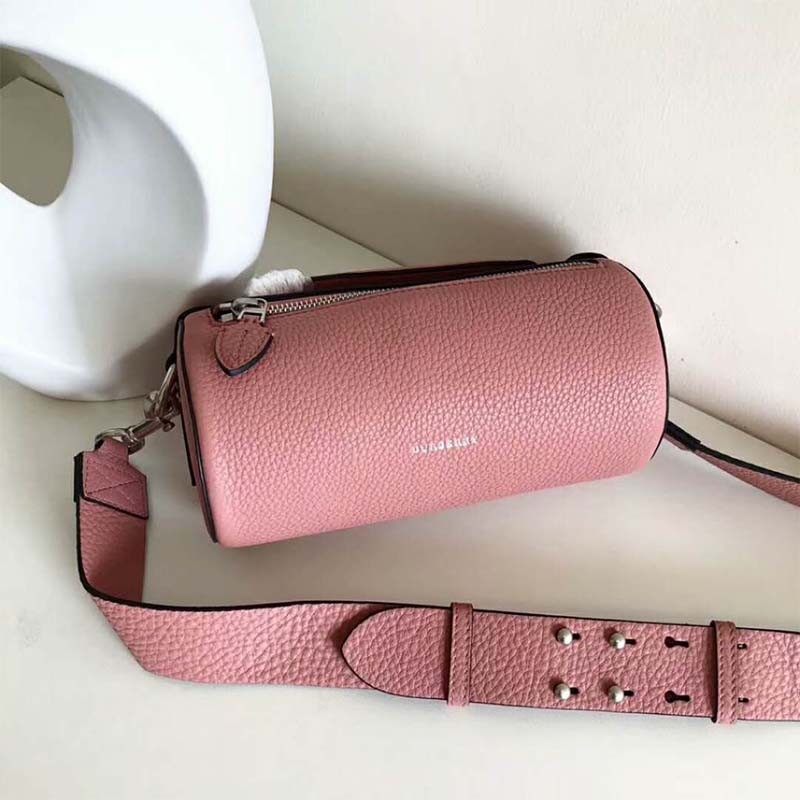 Side angle of Burberry Women The Leather Barrel Bag-Pink displaying silhouette